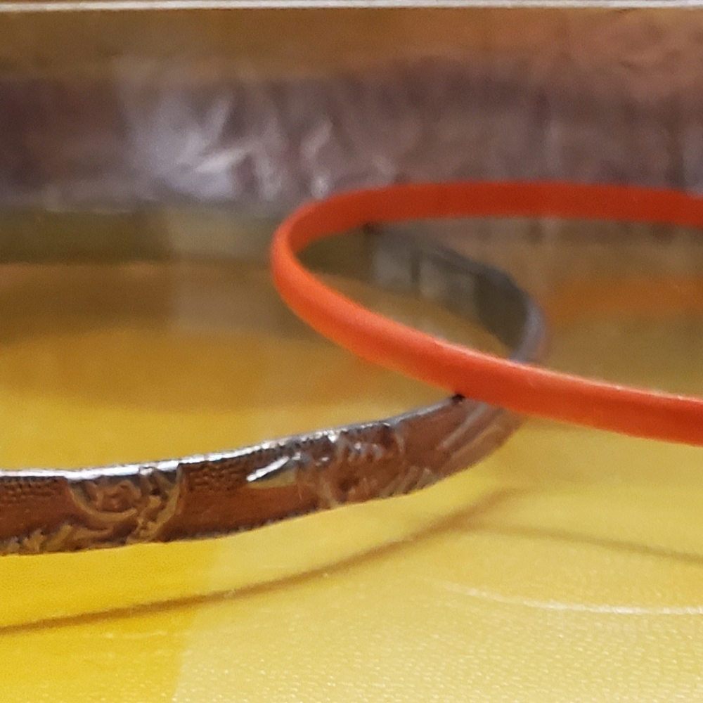 2 Orange and silver bangles